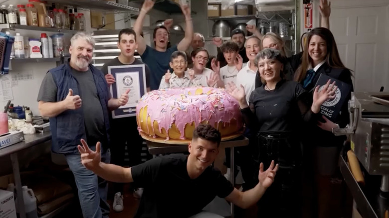 crowd with large donut cake