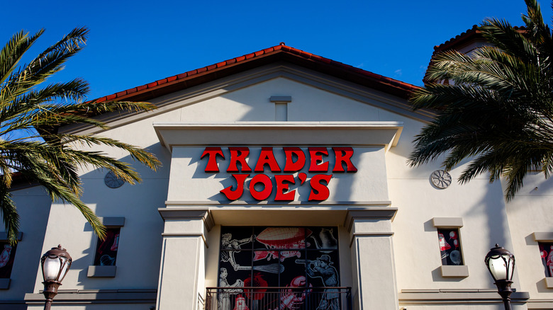 Trader Joe's sign on building with palm trees in foreground
