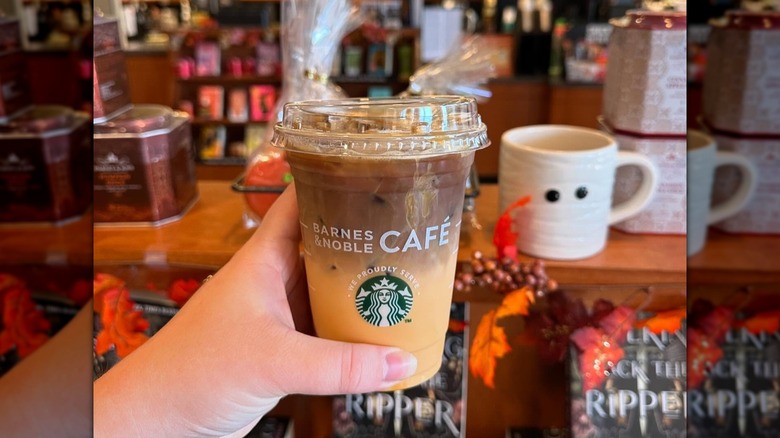 Hand holding a pumpkin spice macchiato