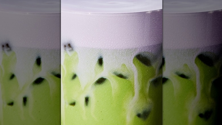 Closeup of iced matcha latte with lavender cold foam