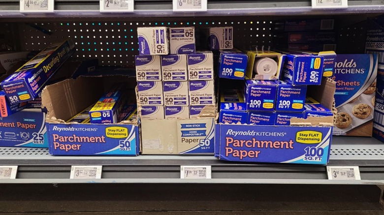 Packages of parchment paper on a shelf.