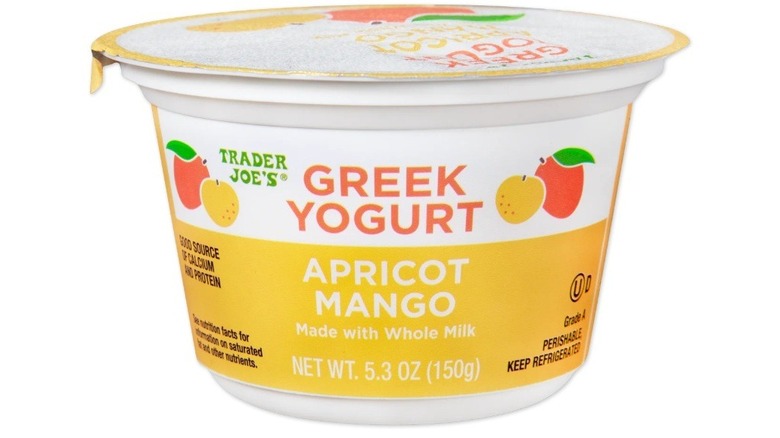 Circular single-serve carton of Greek yogurt with illustrations of apricot and mango on label