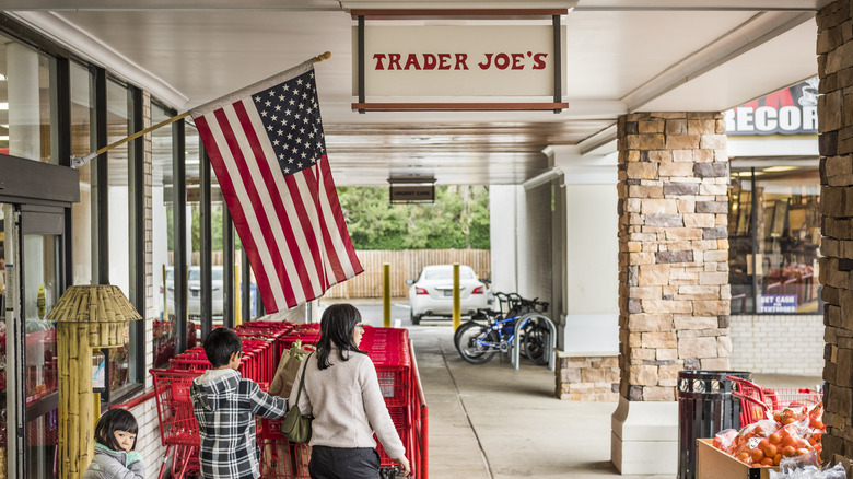 Family returning cart outside Trader Joe's