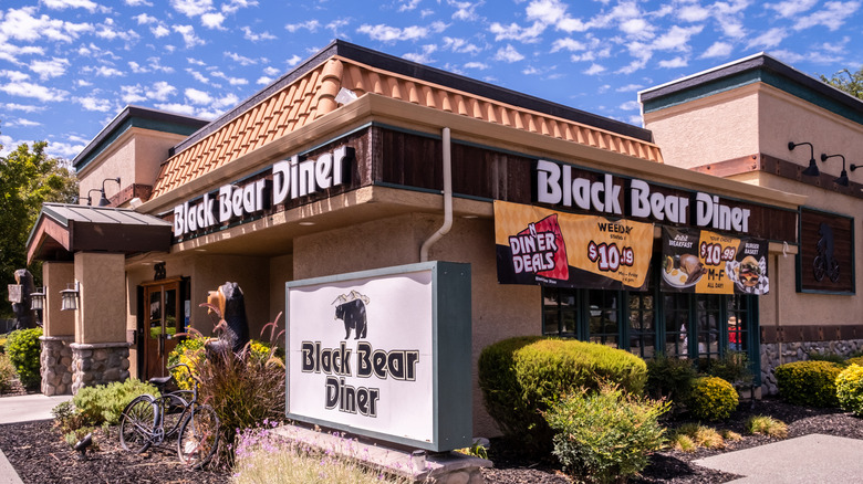 The exterior of a Black Bear Diner with a sign