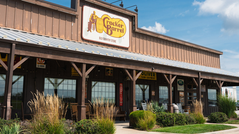 The exterior of Cracker Barrel restaurant with greenery