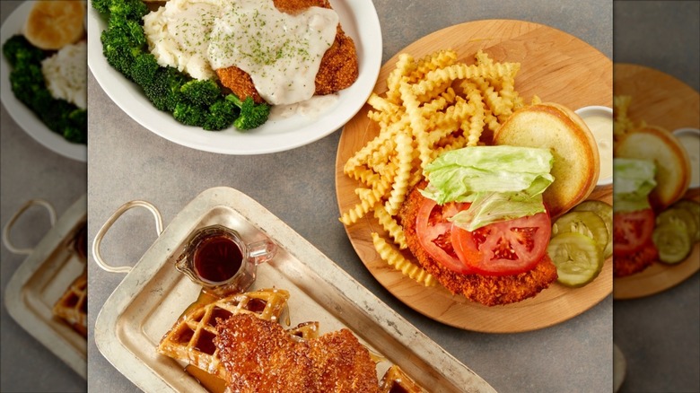 Comfort meal featuring fried steak, burger, and chicken and waffles served at Village Inn
