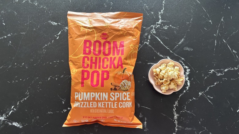 BOOMCHICKAPOP pumpkin spice kettle corn bag next to small bowl of kettle corn