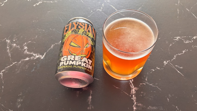 Elysian pumpkin beer can next to beer in glass