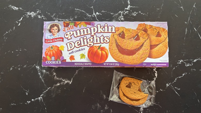Little Debbie pumpkin delights box next to pumpkin delight cookie on countertop
