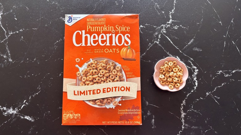 Pumpkin spice Cheerios box next to Cheerios in small bowl