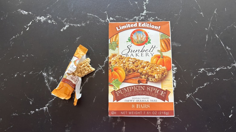 Sunbelt Bakery pumpkin spice granola bars box next to open granola bar on countertop