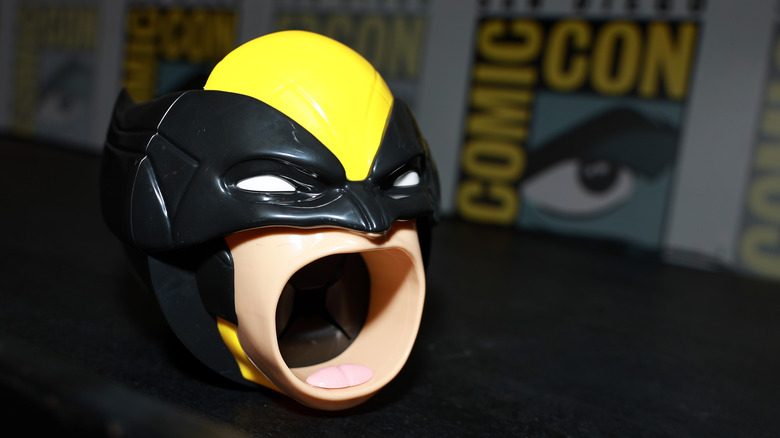 The Wolverine popcorn bucket sits upright against a ComicCon backdrop