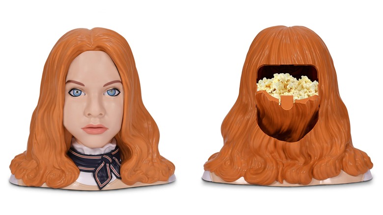 A side-by-side shows the M3GAN 2.0 popcorn bucket with her face on and the back of her head filled with popcorn