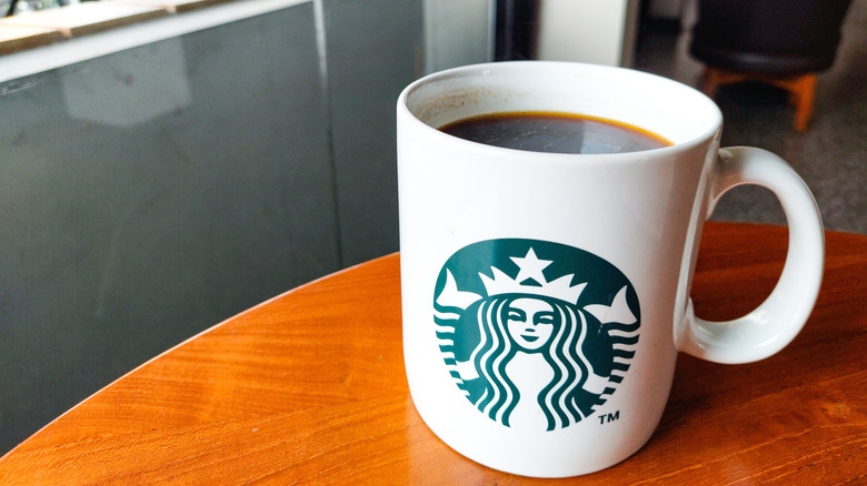 Mug of Starbucks coffee on table