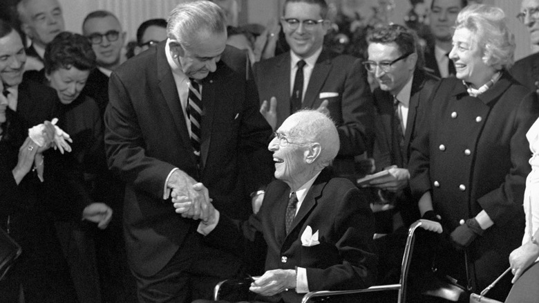 President Lyndon B. Johnson shaking hands with author Upton Sinclair