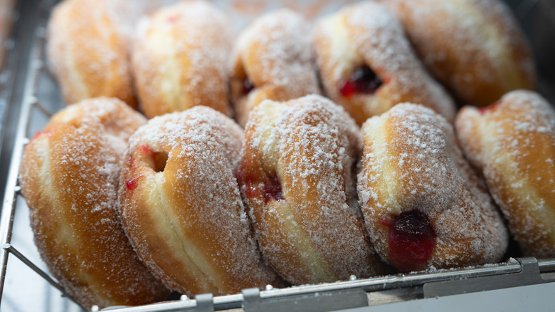Dunkin' Donuts jelly donuts sit in a tray.