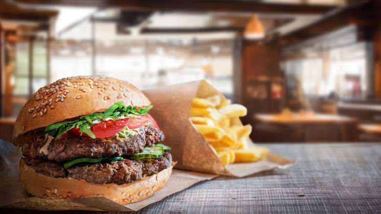Burger and fries on tissue