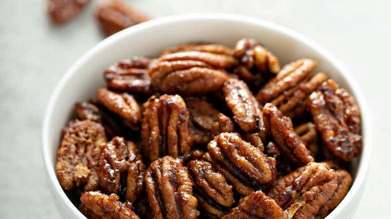 candied pecans in a white bowl