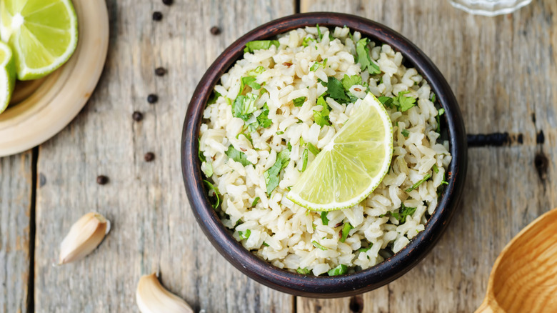A bowl of cilantro lime rice with a lime slice on top