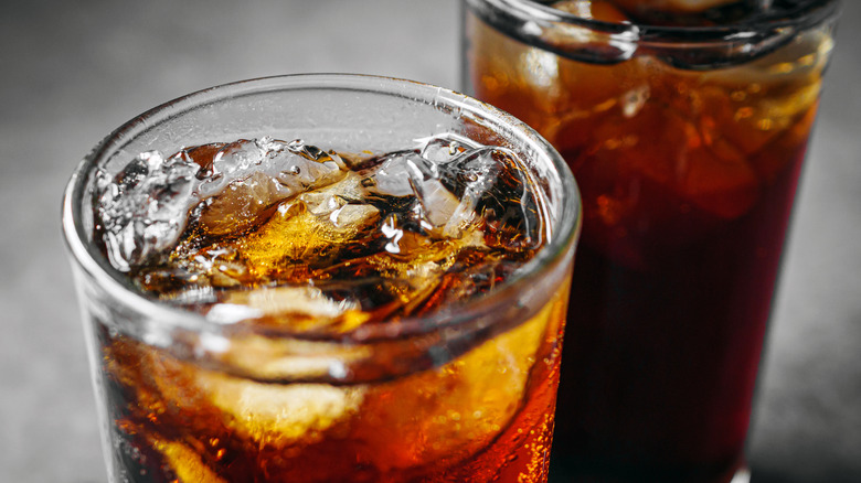 Soda in a glass on a gray table