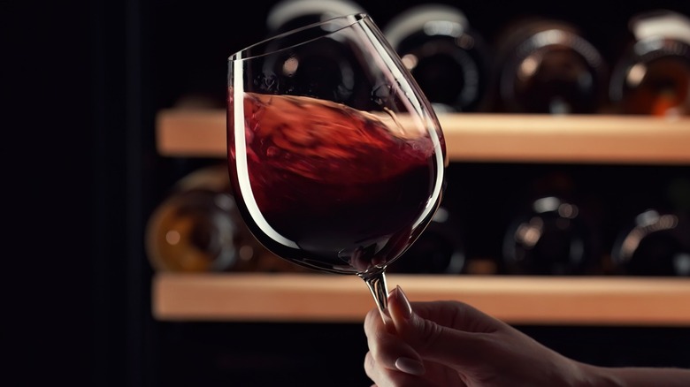 Hand swirling a glass of red wine