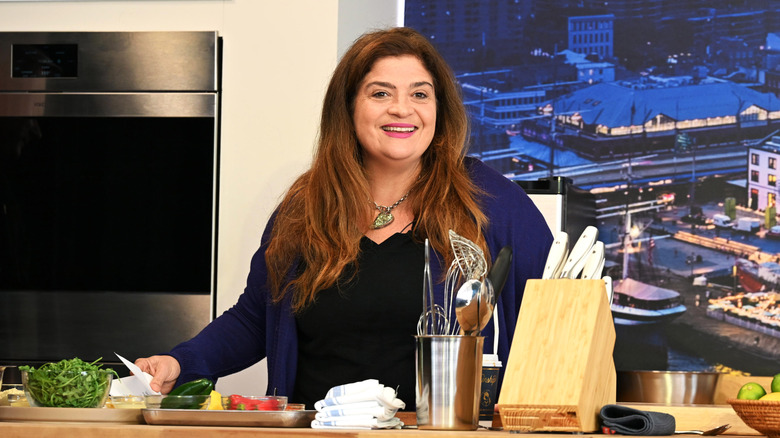 Alex Guarnaschelli behind a cooking countertop