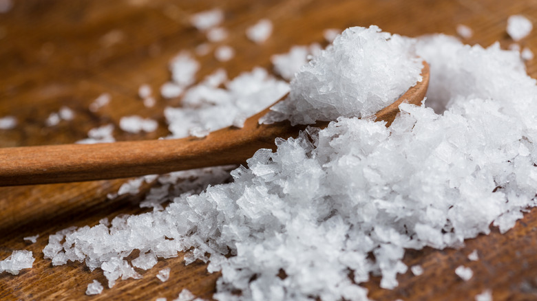 a pile of Maldon salt with a wooden spoon
