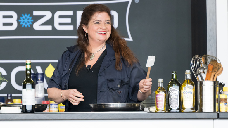 Alex Guarnaschelli on stage doing a cooking demonstration