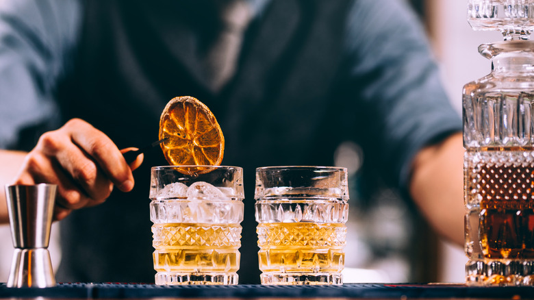 Making whiskey cocktails on a bar