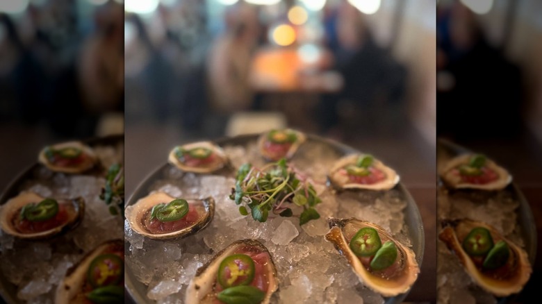 Oysters on ice topped with jalapeños