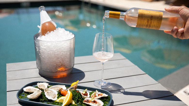 Wine and oysters by pool