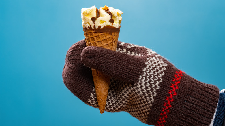 Gloved hand holding ice cream cone