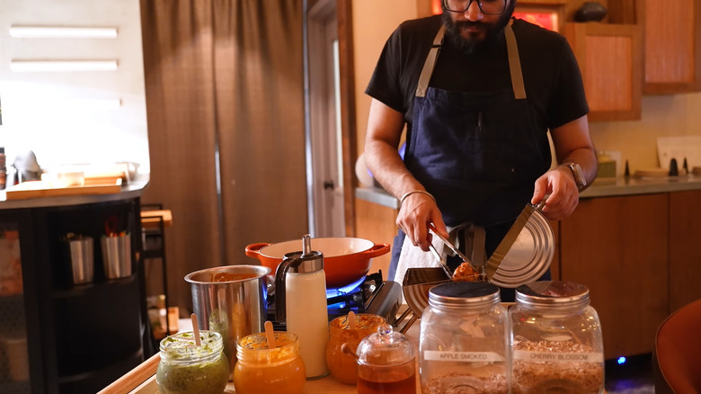 chef preparing the butter chicken experience tableside at Adda