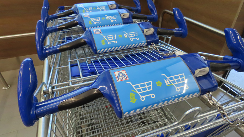Closeup of Aldi shopping carts with quarter slots.