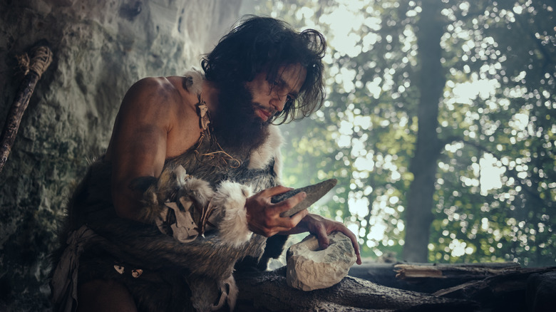 Cave man inventing the knife