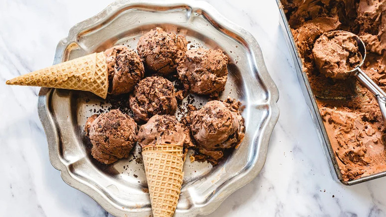 Scoops of ice cream with cones in silver plate