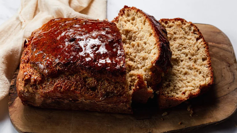 Sliced honey beer bread on wooden cutting board