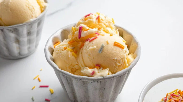 Vanilla ice cream with sprinkles in metal bowl
