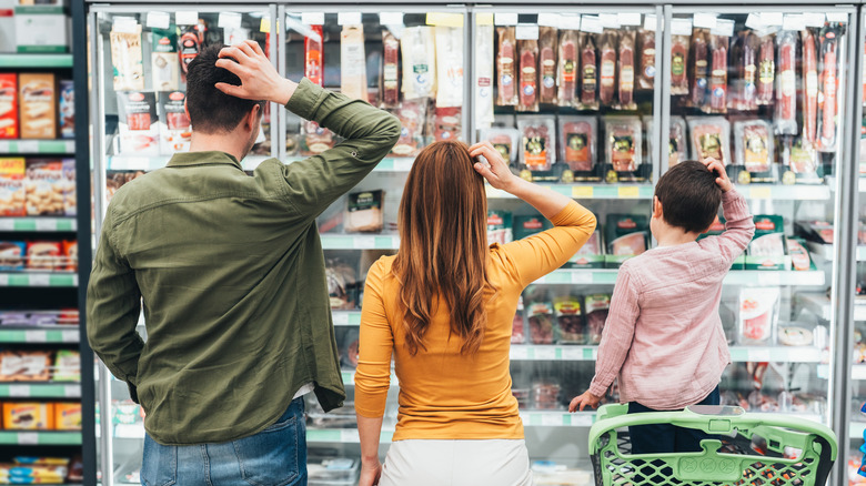 Family in grocery shop confused about what to buy