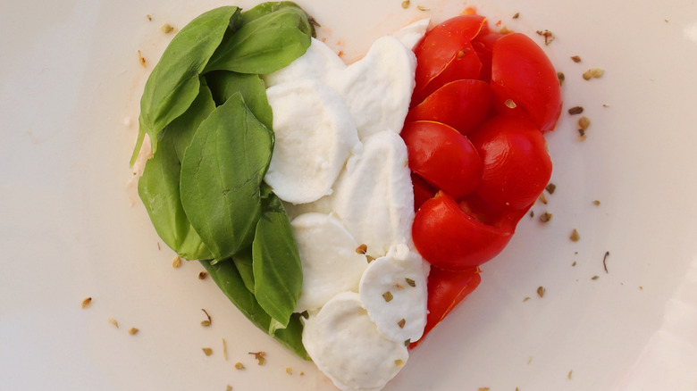 basil, mozzarella, and cherry tomatoes in heart shape