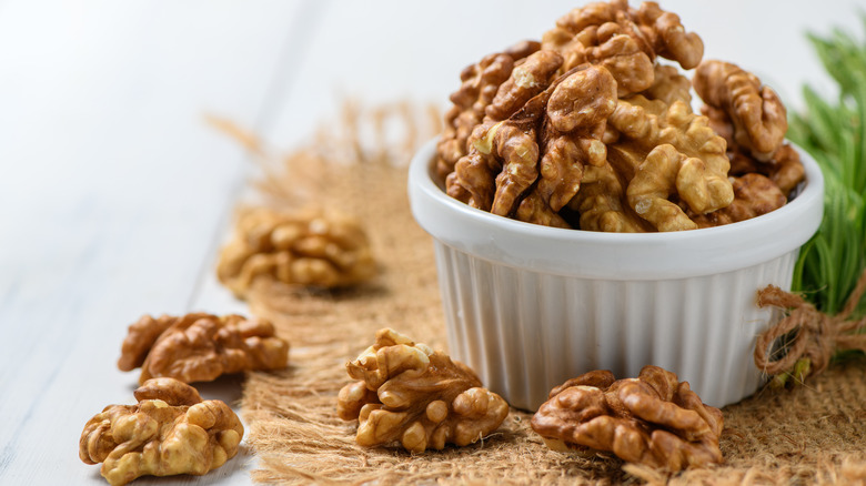A pile of walnuts in a white bowl