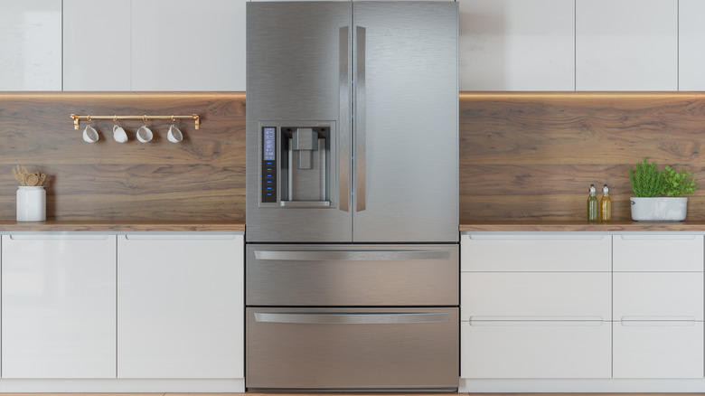 Large stainless steel French-door fridge with two bottom drawers.
