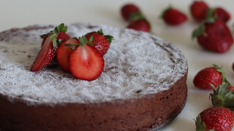 nut cake with powdered sugar and fruit