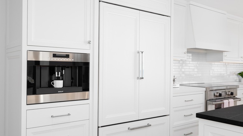 white kitchen with built-in Sub-Zero fridge