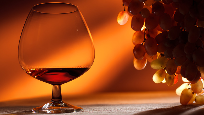 cognac snifter and white grapes