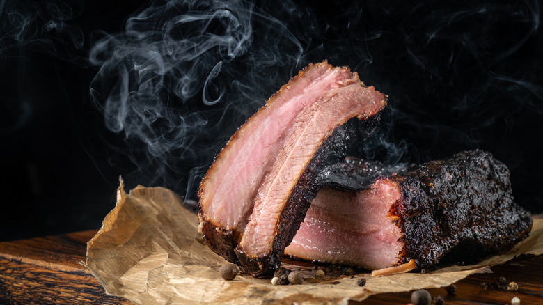 Steaming hot sliced brisket on a butting board