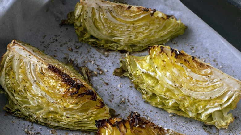 Baked cabbage wedges on parchment paper