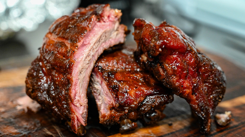 close up of marinated pork ribs on a wooden cutting board