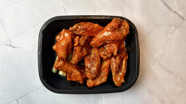 Applebee's Buffalo chicken wings in a plastic takeout container