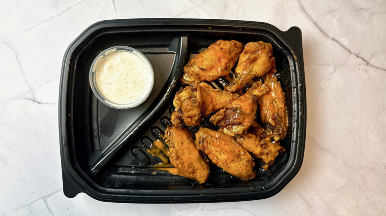 Longhorn Steakhouse chicken wings in a plastic takeout container